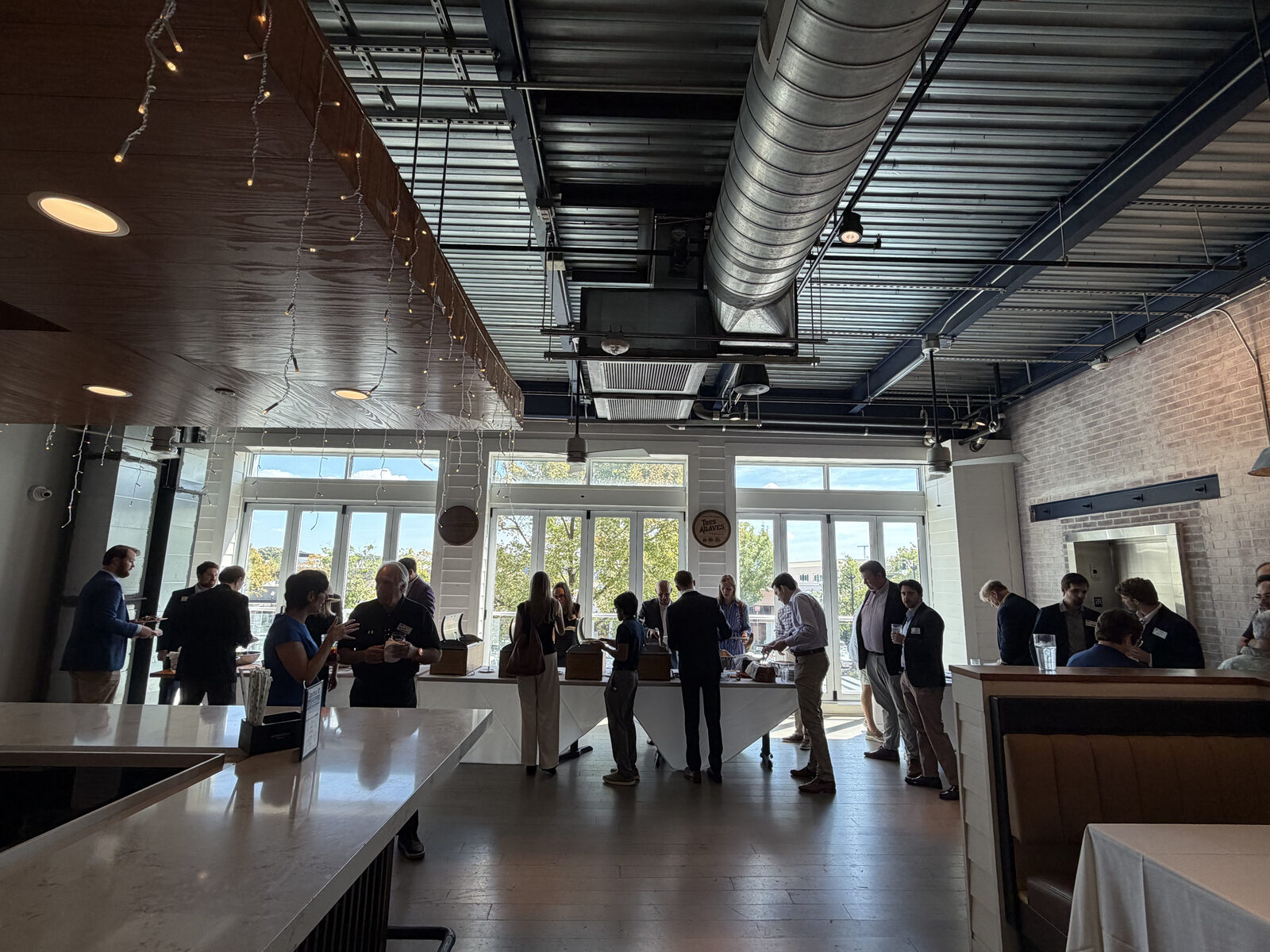 Guests networking near the windows